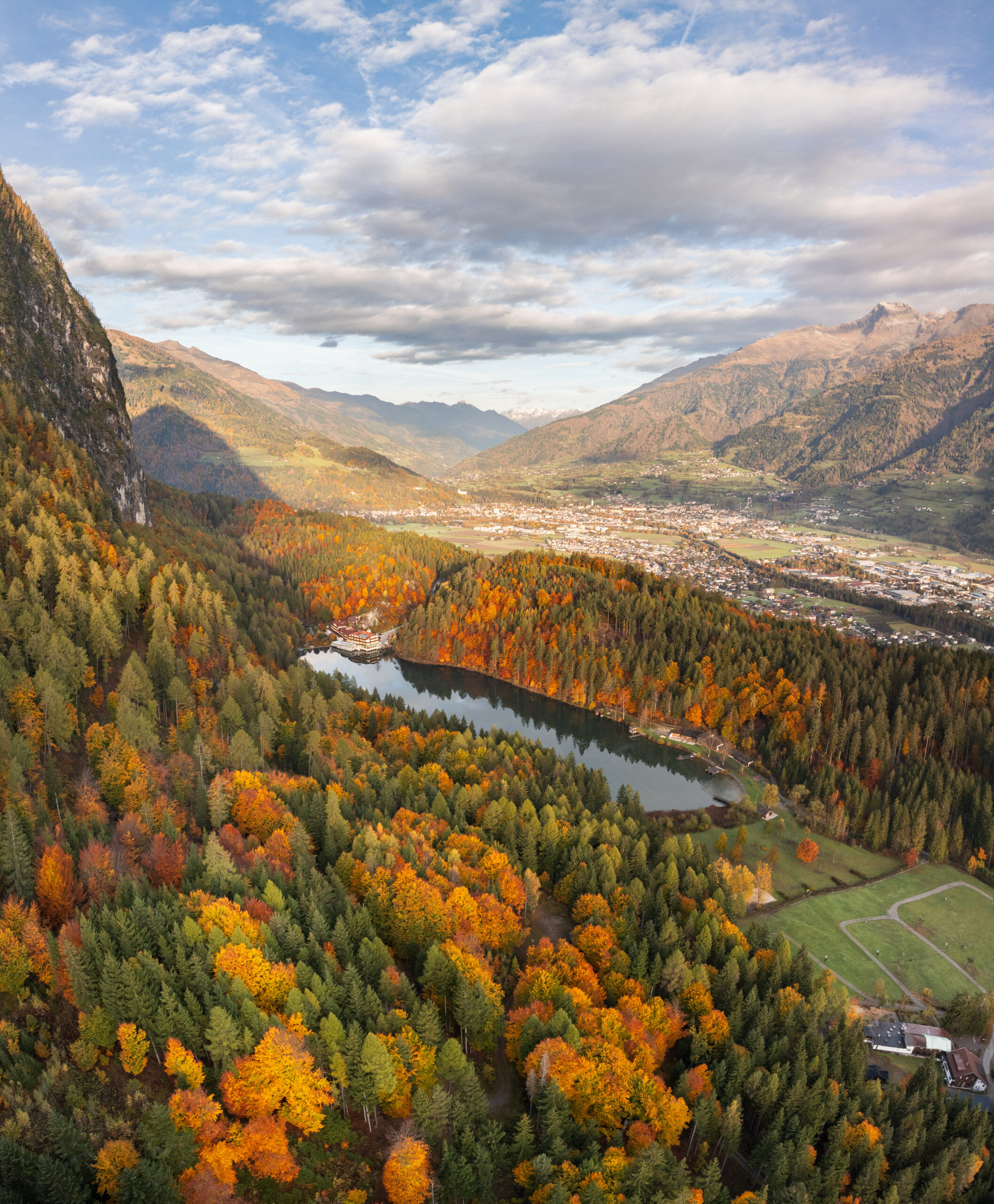 Goldener Herbst am Tristachersee. Drohnenaufnahme von oben.